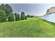 Large manicured lawn in back yard with white fence at 1890 Sandal Brook Rd, Fort Mill, SC 29707