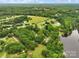 An aerial view showcasing the property near a lake surrounded by green trees and lush scenery at 2021 Beamguard Rd, Clover, SC 29710