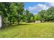 An expansive backyard with mature trees, swingset and ample room for recreation at 2021 Beamguard Rd, Clover, SC 29710