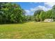 A expansive backyard features mature trees, a swing set and ample space at 2021 Beamguard Rd, Clover, SC 29710