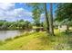 Beautiful backyard features a picturesque lake, private dock, and lush greenery at 2021 Beamguard Rd, Clover, SC 29710