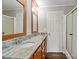 Modern bathroom with wood cabinets, granite countertops, and a glass enclosed shower at 2021 Beamguard Rd, Clover, SC 29710