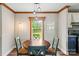 Cozy dining area with a round table, stylish lighting, and a view of the outdoors at 2021 Beamguard Rd, Clover, SC 29710