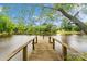 Wooden dock leading to the lake surrounded by lush greenery and trees at 2021 Beamguard Rd, Clover, SC 29710