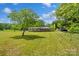 Spacious property showcasing a home with a sprawling lawn and mature trees at 2021 Beamguard Rd, Clover, SC 29710