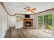 Comfortable living room with a brick fireplace, wood-look floors, and sliding doors to the deck at 2021 Beamguard Rd, Clover, SC 29710