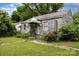 Exterior of a one story home needing renovation and new landscaping at 2308 Vanderbilt Rd, Charlotte, NC 28206