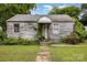 Exterior of a one story home needing renovation and new landscaping at 2308 Vanderbilt Rd, Charlotte, NC 28206