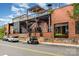 Exterior view of a brick building with a metal structure, stairs, and storefront on a sunny day at 2308 Vanderbilt Rd, Charlotte, NC 28206