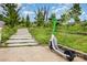 Scenic walking path featuring greenery, trees, and a modern scooter, perfect for neighborhood exploration at 2308 Vanderbilt Rd, Charlotte, NC 28206