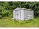Exterior shot of shed with chair. Shed provides extra storage space at 2308 Vanderbilt Rd, Charlotte, NC 28206