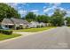 Street view featuring single-Gathering homes on a street with mature trees and greenery at 2308 Vanderbilt Rd, Charlotte, NC 28206