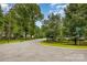 Street corner view in a neighborhood with mature trees and well-maintained lawns at 2308 Vanderbilt Rd, Charlotte, NC 28206