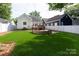 Lush green backyard featuring a cozy fire pit, well-maintained lawn, and an inviting deck, perfect for outdoor living at 2412 Chesterfield Ave, Charlotte, NC 28205