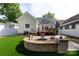 Picturesque backyard featuring a custom firepit, lush greenery, and a charming deck, perfect for outdoor enjoyment at 2412 Chesterfield Ave, Charlotte, NC 28205