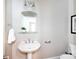 Powder room featuring pedestal sink, mirror, and neutral wall color at 2412 Chesterfield Ave, Charlotte, NC 28205
