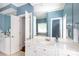 Bathroom featuring double sinks, white cabinets, quartz countertop and ample counter space at 2412 Chesterfield Ave, Charlotte, NC 28205