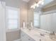Bathroom featuring a double vanity with large mirror and sconces at 2412 Chesterfield Ave, Charlotte, NC 28205