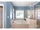 Bright bathroom with a large soaking tub, walk-in shower and neutral tile, perfect for relaxation at 2412 Chesterfield Ave, Charlotte, NC 28205