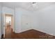 Well-lit bedroom with hardwood floors, closet, and view to adjacent room at 2412 Chesterfield Ave, Charlotte, NC 28205