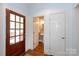 Entryway with a stained wood door, wood floors and half bath with pedestal sink at 2412 Chesterfield Ave, Charlotte, NC 28205