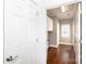 View of hallway leading to laundry room with hardwood floors and white cabinets at 2412 Chesterfield Ave, Charlotte, NC 28205