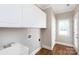Laundry room with sink, white cabinets, and hardwood floors at 2412 Chesterfield Ave, Charlotte, NC 28205