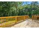 Spacious back deck with wood railing, offering great view of the backyard, perfect for relaxing outdoors at 251 Hall Nw Ave, Concord, NC 28027
