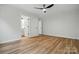Bedroom featuring wood floors, a ceiling fan, and a view of the attached bathroom at 251 Hall Nw Ave, Concord, NC 28027