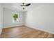Bedroom with hardwood floors, ceiling fan, and a window that brings natural light into the room at 251 Hall Nw Ave, Concord, NC 28027