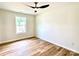 Neutral bedroom featuring a modern ceiling fan and a large window providing natural light and a pleasant view at 251 Hall Nw Ave, Concord, NC 28027