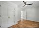 Bedroom with hardwood floors, ceiling fan, and closet featuring double doors and gold hardware at 251 Hall Nw Ave, Concord, NC 28027