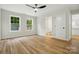 Bright, spacious bedroom showcasing wood flooring, a modern fan, and natural light at 251 Hall Nw Ave, Concord, NC 28027