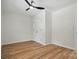 A bright, minimalist bedroom showcases a ceiling fan, light hardwood floors, and a double-door closet at 251 Hall Nw Ave, Concord, NC 28027