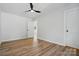 Bedroom with hardwood floors, ceiling fan, and an open doorway leading to the hallway at 251 Hall Nw Ave, Concord, NC 28027