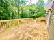 New wooden deck for outdoor gatherings, perfect for entertaining and enjoying the surrounding wooded landscape at 251 Hall Nw Ave, Concord, NC 28027