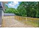 Brand new wooden deck, freshly constructed, offers a spacious outdoor living area with serene backyard views at 251 Hall Nw Ave, Concord, NC 28027