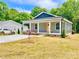 Charming home with a gray exterior, well-manicured lawn and a newly planted red maple tree in the front yard at 251 Hall Nw Ave, Concord, NC 28027
