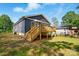 Back exterior view of home featuring a wood deck, siding, and great lawn space at 251 Hall Nw Ave, Concord, NC 28027
