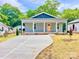 Charming gray home with a covered porch and a long concrete driveway at 251 Hall Nw Ave, Concord, NC 28027
