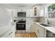 Modern kitchen featuring white cabinets, marble counters, and stainless steel appliances at 251 Hall Nw Ave, Concord, NC 28027