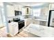 A modern kitchen with a white countertop island and stainless steel appliances at 251 Hall Nw Ave, Concord, NC 28027