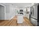 Open kitchen with white cabinets, stainless steel appliances and a central island at 251 Hall Nw Ave, Concord, NC 28027