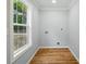 Clean laundry room featuring wood flooring, trim and natural light from a large window at 251 Hall Nw Ave, Concord, NC 28027