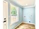 Laundry room with wood-look floors and a large window to the backyard at 251 Hall Nw Ave, Concord, NC 28027