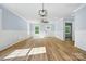 Sunlit living room featuring hardwood floors and views of the front yard at 251 Hall Nw Ave, Concord, NC 28027