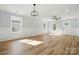 Bright living room featuring fresh paint, wood floors, trim work and a modern ceiling fan at 251 Hall Nw Ave, Concord, NC 28027