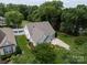 An aerial view shows this home with mature landscaping, fenced backyard, and a well-kept lawn at 2598 Old Ashworth Nw Ln, Concord, NC 28027