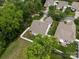 An aerial view of a home showcasing a well-maintained backyard with a white fence and mature trees at 2598 Old Ashworth Nw Ln, Concord, NC 28027