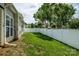 Backyard featuring a lush green lawn and a tall white fence for privacy at 2598 Old Ashworth Nw Ln, Concord, NC 28027